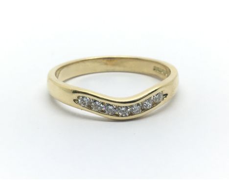 An 18ct yellow gold wishbone shaped ring with seven diamonds, approx 0.25ct, ring size approx O