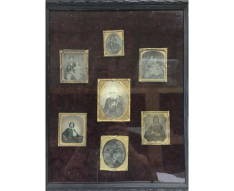 A framed and glazed collection of Victorian portrait photographs.