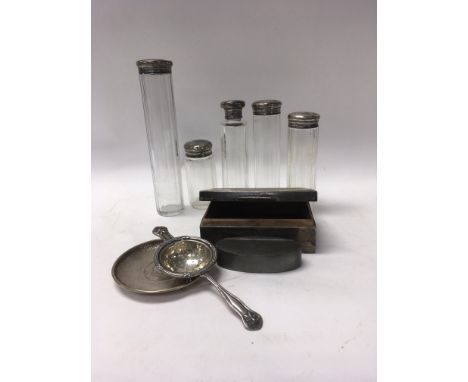 A small dish inset with silver coin together with silver top perfume bottles A cigarette box , tea strainer and a pewter snuf