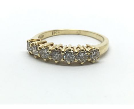 An 18ct yellow gold and diamond half eternity ring having a row of seven diamonds, approx 0.66ct, ring size approx M/N