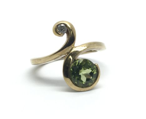 A 9ct gold peridot and diamond ring, approx size J/K