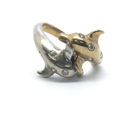 A 9ct yellow gold ring in the shape of two dolphins with ten inset diamonds, ring size approx M/N