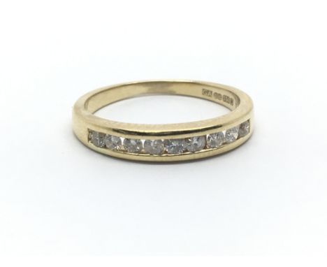 An 18ct yellow gold half eternity ring having nine diamonds, ring size approx L/M