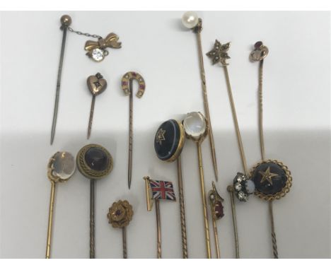 A collection of 15 stick pins including gold.