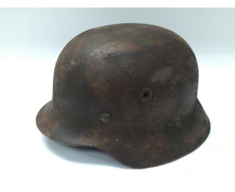 German WW2 style M35 steel helmet with camp paintwork, complete with liner, service worn