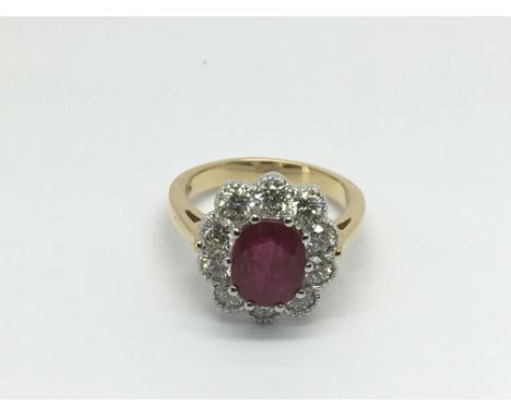 An 18ct gold ruby and diamond cluster ring set with a central oval cut ruby, approx 2.50ct, RBC diamonds approx 1.50ct, appro