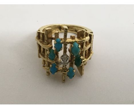 A 18 ct gold contemporary  ring Inset with turquoise stones and a single diamond size H11 grams .