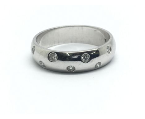 An 18ct white gold ring with eight small diamonds, ring size approx K/L