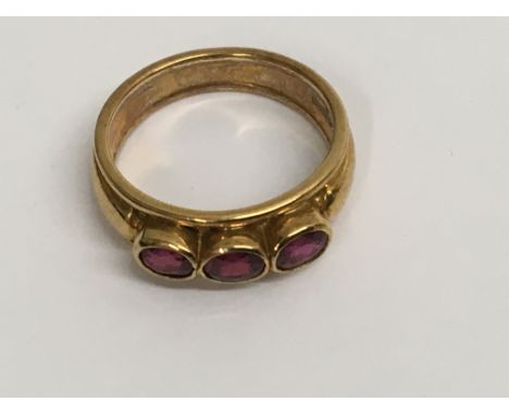 A 18 ct gold ring inset with three rubies size k