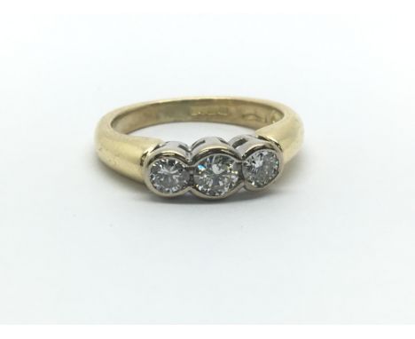 An 18ct yellow gold and three stone diamond ring, approx 0.40ct, ring size approx F/G