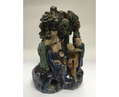 A ceramic wall vase decorated with applied decoration of figures beneath a tree, approx height 22cm - NO RESERVE