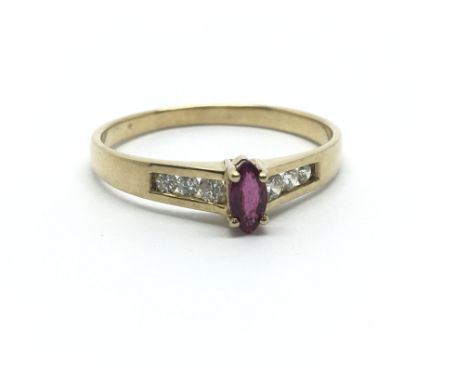 A 14ct yellow gold ring the central ruby flanked by six diamonds, ring size approx N/O