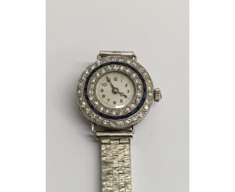 A Art Deco 9 ct white gold cocktail watch the dial surrounded with sapphire and diamonds.Total weight 25 grams .
