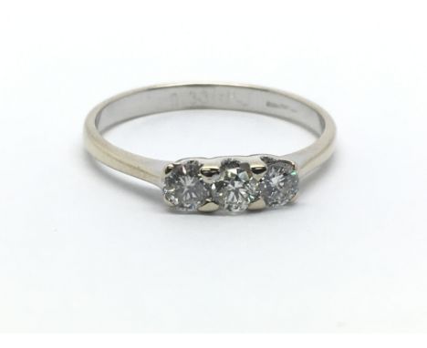 An 18ct white gold and three stone diamond ring, approx 0.33ct, ring size approx L/M