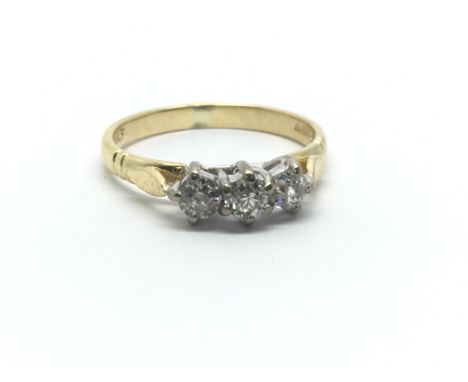 An 18ct yellow gold and three stone diamond ring, 0.50ct, ring size approx L