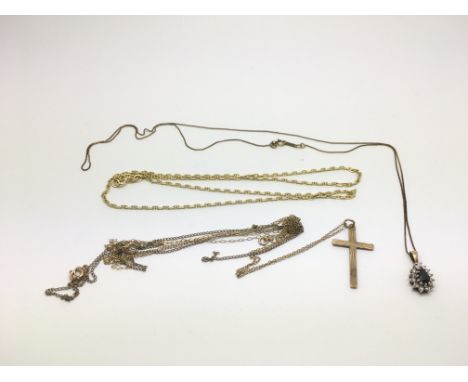 Three gold necklaces, one set with a sapphire and diamond pendant, approx total weight 9g.