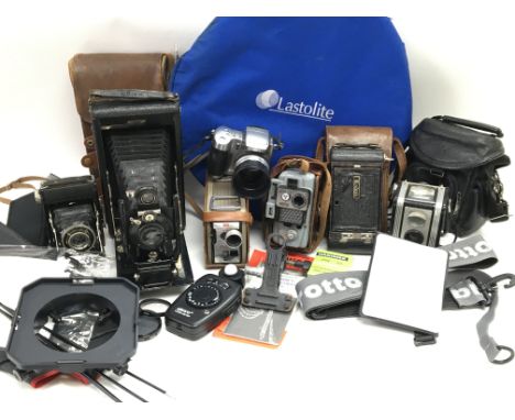 A box containing a collection of cameras and photographic accessories including a Kodak TLR, Kodak folding camera with case, 