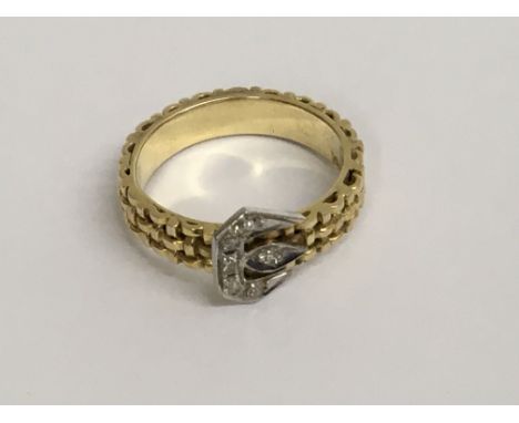 A 14 k gold buckle ring inset with diamonds size M total weight 5 grams