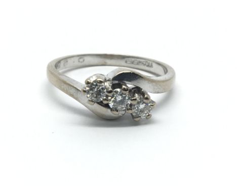 An 18ct white gold, three stone diamond ring, approx 0.25ct, ring size approx M