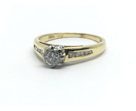An 18ct yellow gold ring, having central solitaire diamond and diamond shoulders, approx 0.5ct, ring size approx M