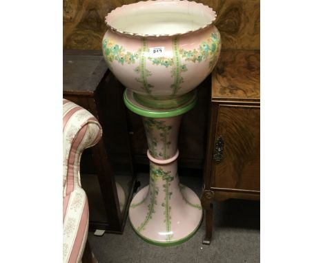 An Edwardian ceramic jardiniere and pedestal decorated with garlands of flowers on a pale pink ground - NO RESERVE