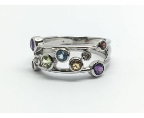 A 9ct white gold ring having multi-coloured stones, ring size approx M