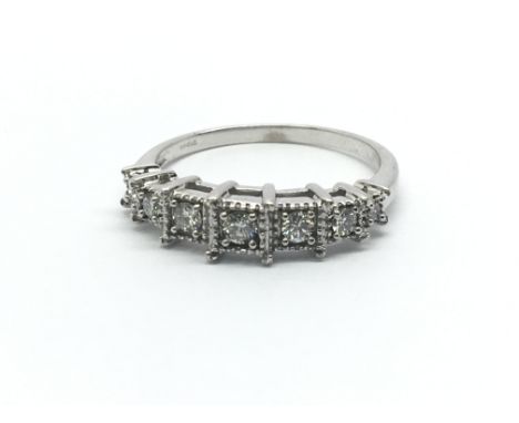 An 18ct white gold ring having seven diamonds, approx 0.23ct, approx size M/N