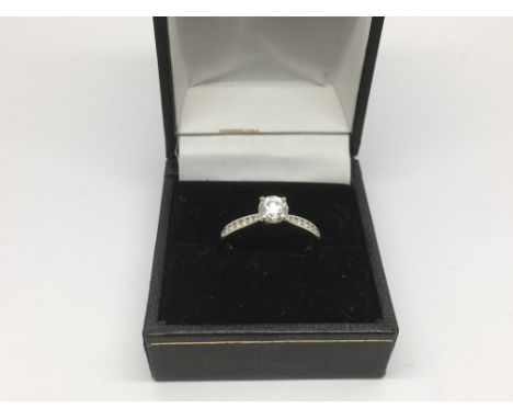 An 18ct white gold solitaire 55 point diamond ring, approx 3g and approx size N.