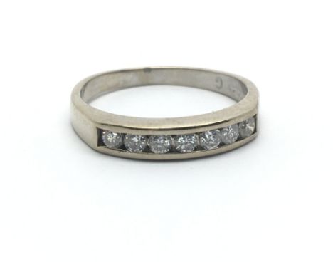 An 18ct white gold seven diamond half eternity ring, approx 0.25ct, ring size approx M