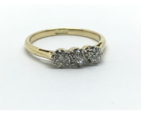 An 18ct yellow gold and three stone diamond ring, approx 0.33ct, ring size approx K/L