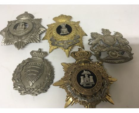 Five Military Regimental Helmet plates including Essex Rifle Volunteers with makers name to the reverse S W Silver &amp; Co L