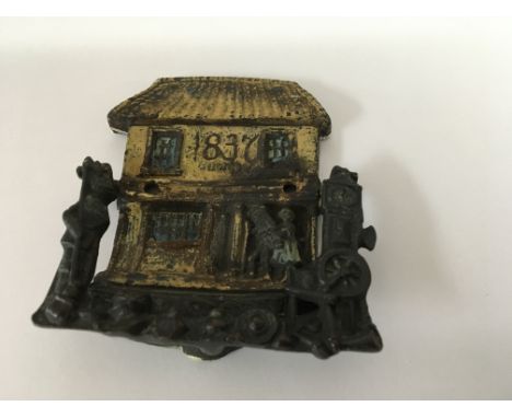 A 19 th century 1837 cold painted door knocker in the form of a couple entering a cottage.