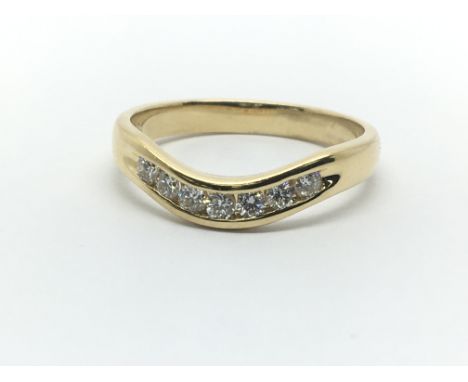 An 18ct yellow gold wishbone shaped ring having a row of seven diamonds, approx 0.25ct, ring size approx N/O