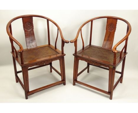 Pair of Vintage Chinese Huanghuali Ox Bow Back Chairs. Hand Carved, Woven Rattan Seats. Unsigned. Good Condition. Measures 37