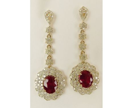 Pair AIG Certified 5.62 Carat Ruby, 3.13 Carat Diamond, 14 Karat Yellow Gold Dangle Earrings. The rubies oval mixed cut with 