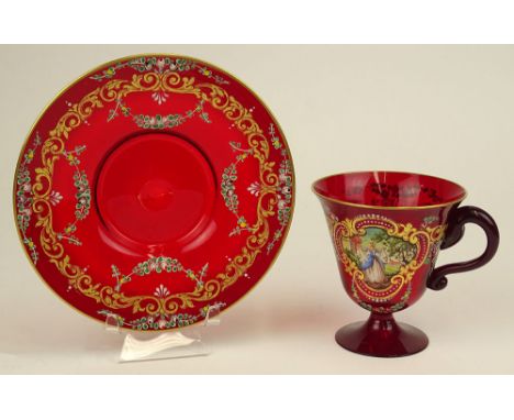 Moser style hand blown Bohemian glass cup and saucer set. Hand painted "romantic" scene as center panel. Gilt and floral deco