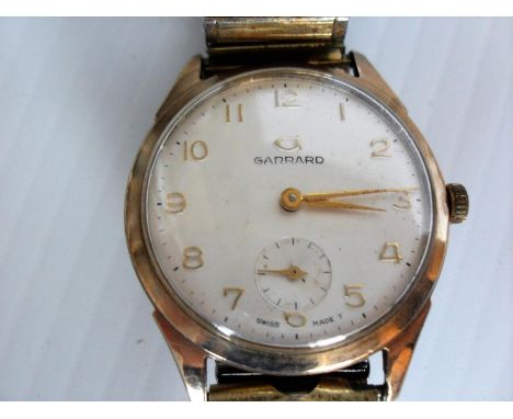 A 1960s Garrard gentleman’s 9ct gold dress watch, the silvered dial with applied gold Arabic numerals, and subsidiary seconds