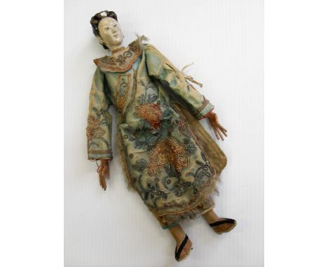 A late 19th century articulated carved ceramic and wood Chinese female doll with painted features, traditional dress (showing