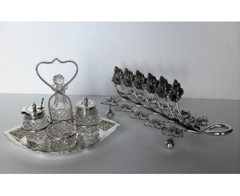 A Victorian silver plated cruet stand with cut-glass bottles by Henry Wilkinson Ltd., Sheffield and a silver plated toast rac