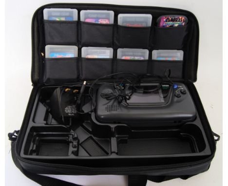 An original vintage Sega made Game Gear console, within an original soft case with a quantity of games

POSTAGE: UK Postage o