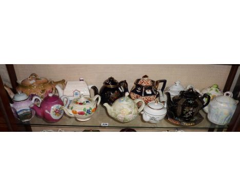 Shelf of vintage and older china teapots (13)