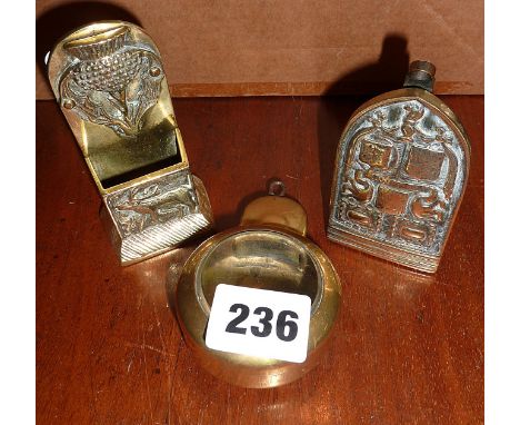 Victorian brass and glass pocket watch holder, a Scottish embossed matchbox holder and embossed brass door knocker inscribed 