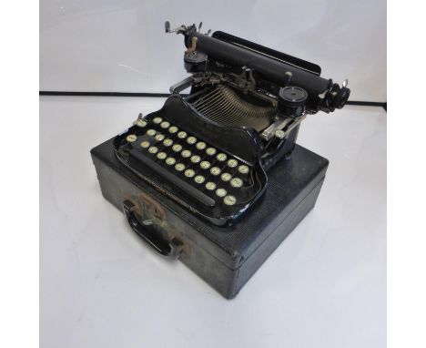 A Corona Travelling Typewriter, with its carrying case, in apparently working condition, together with a set of letter scales