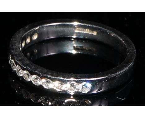 A platinum channel set fourteen stone diamond chip ring, size J/K, marked 950, 3.8g 