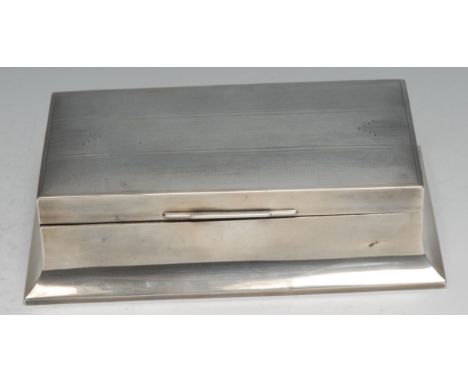 An Art Deco silver cigarette box, hinged cover with geometric motifs on an engine turned ground, spreading base, cedar-lined 