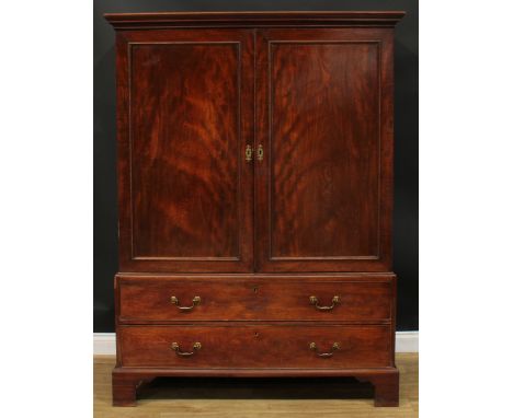 A George III mahogany hanging press cupboard, formerly a linen press, moulded cornice above a pair of panel doors enclosing a