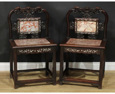 A pair of Chinese hardwood and mother of pearl marquetry chairs, each with a shaped cresting rail carved with clouds and cent