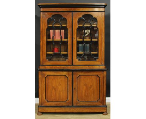 A 19th century walnut and ebonised library bookcase, moulded cornice above a pair of glazed doors, the projecting base with a