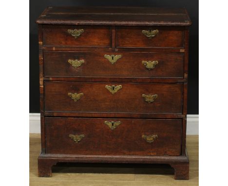 A George I/II oak chest, of small proportions, slightly oversailing top above two short and three long graduated drawers, ski