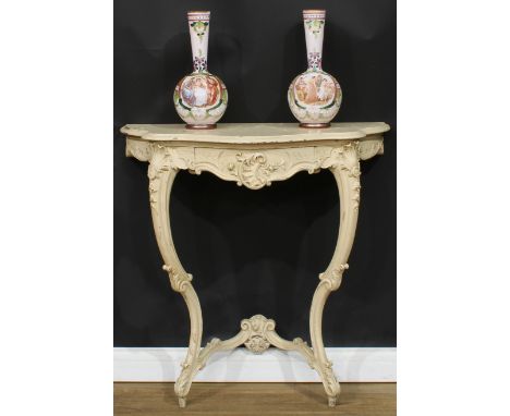 A Rococo Revival painted console table, oversailing serpentine top above a frieze drawer, carved with scrolls, trellis, shell